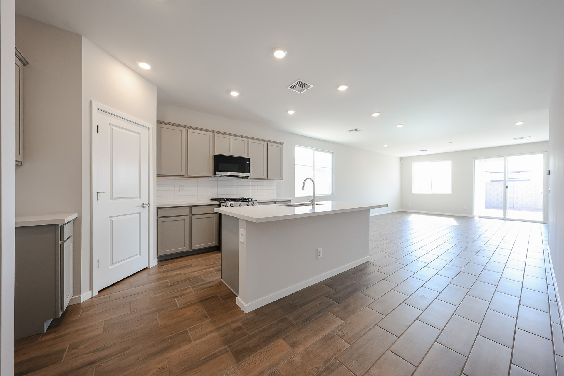 A kitchen with white cabinets.