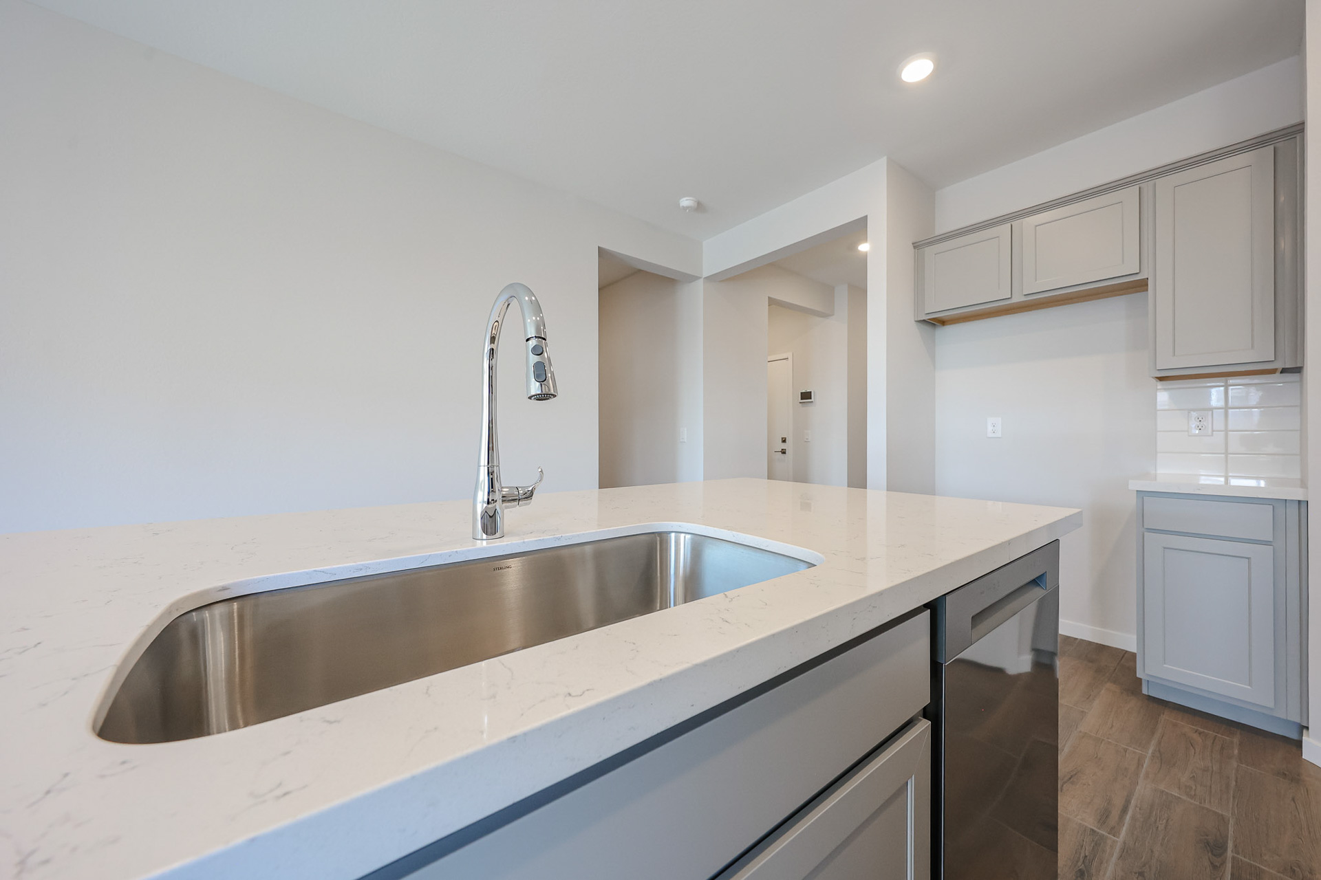 A kitchen with a sink and cabinets.