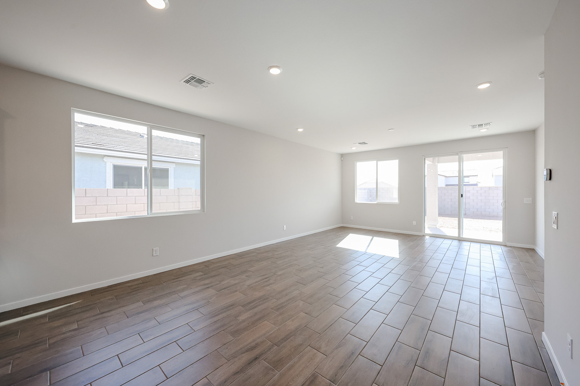 A room with windows and wood floor.