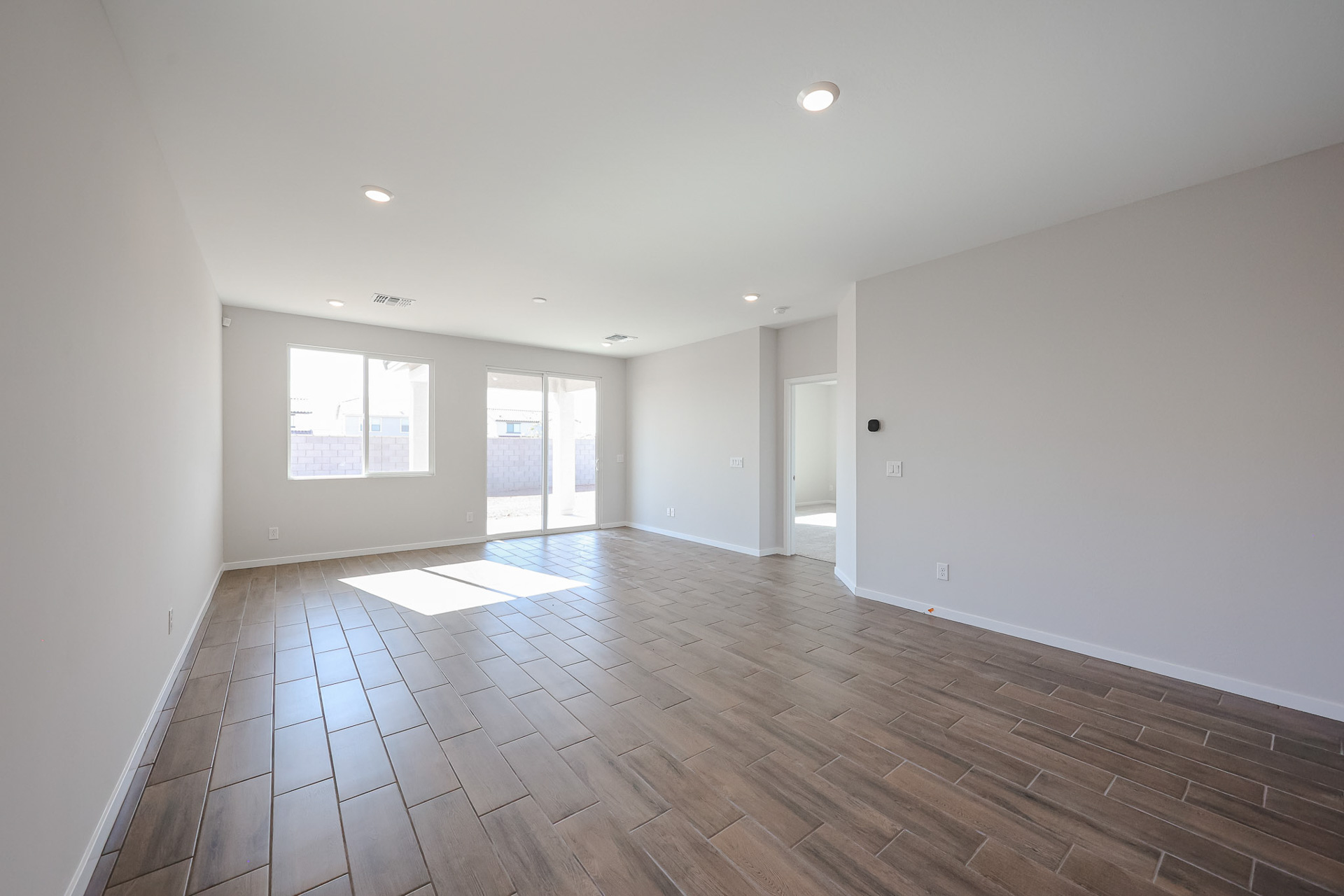 A room with a wood floor and white walls.