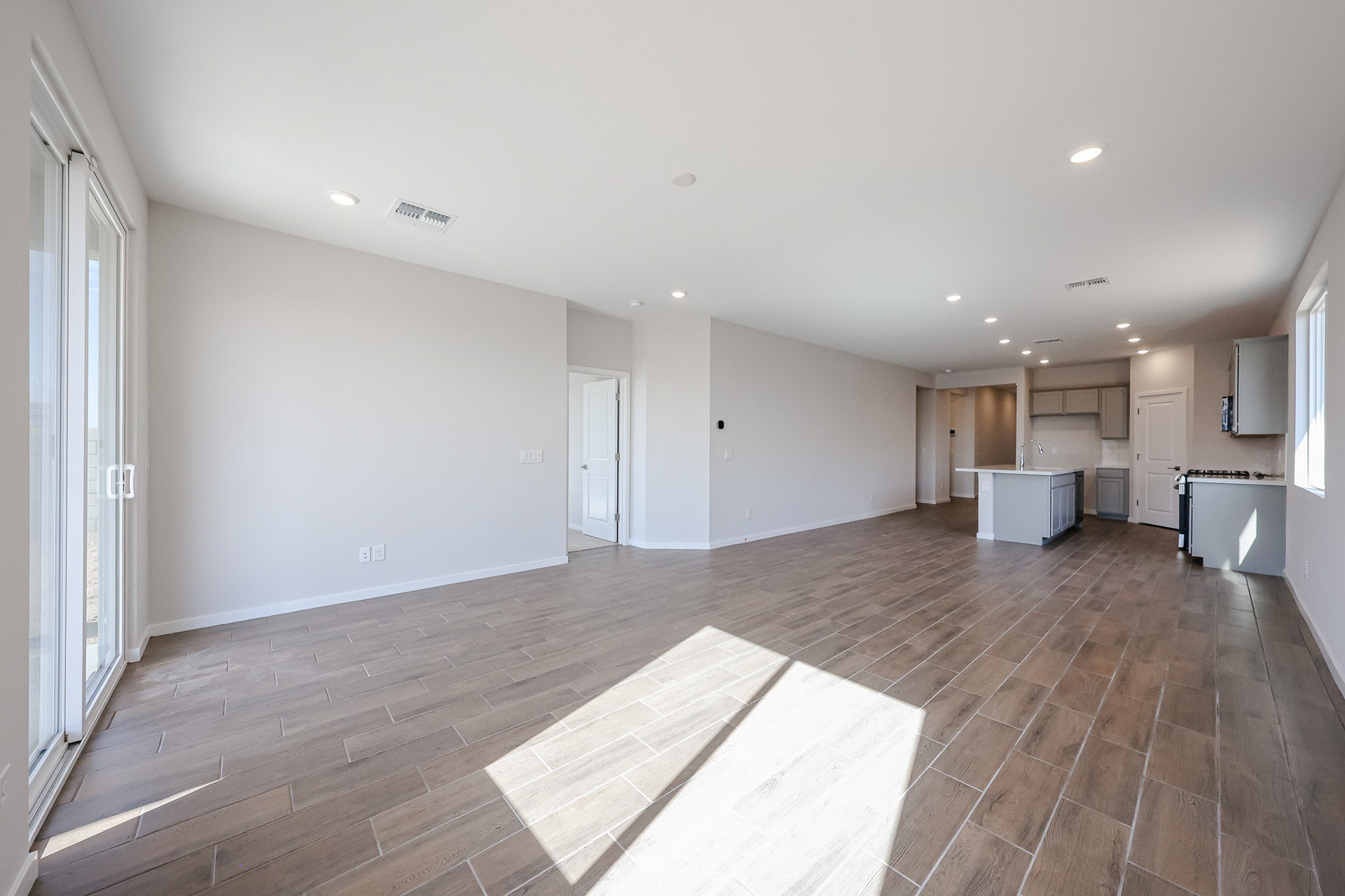 A room with a wood floor and white walls.