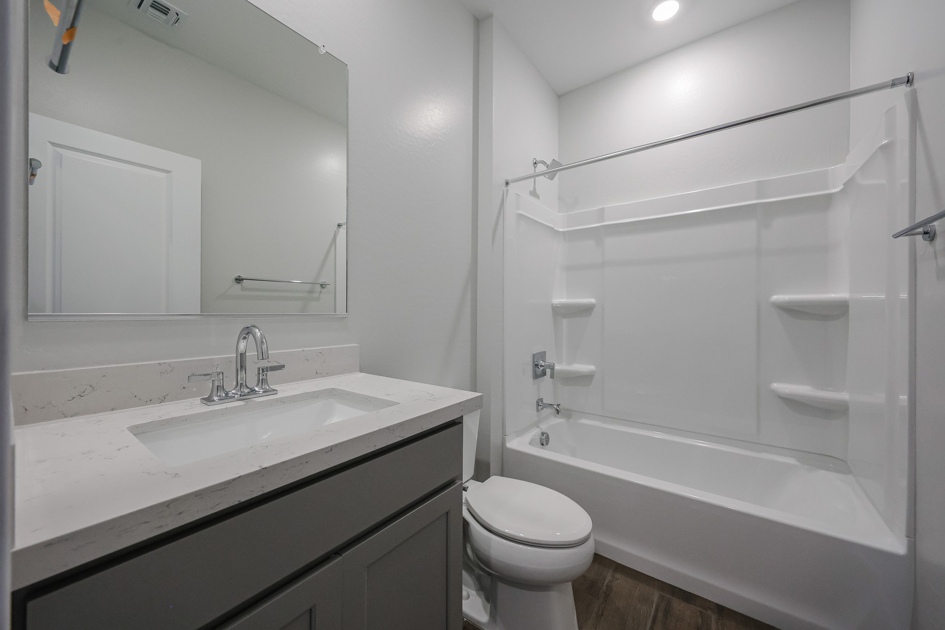 A bathroom with a tub sink and toilet.