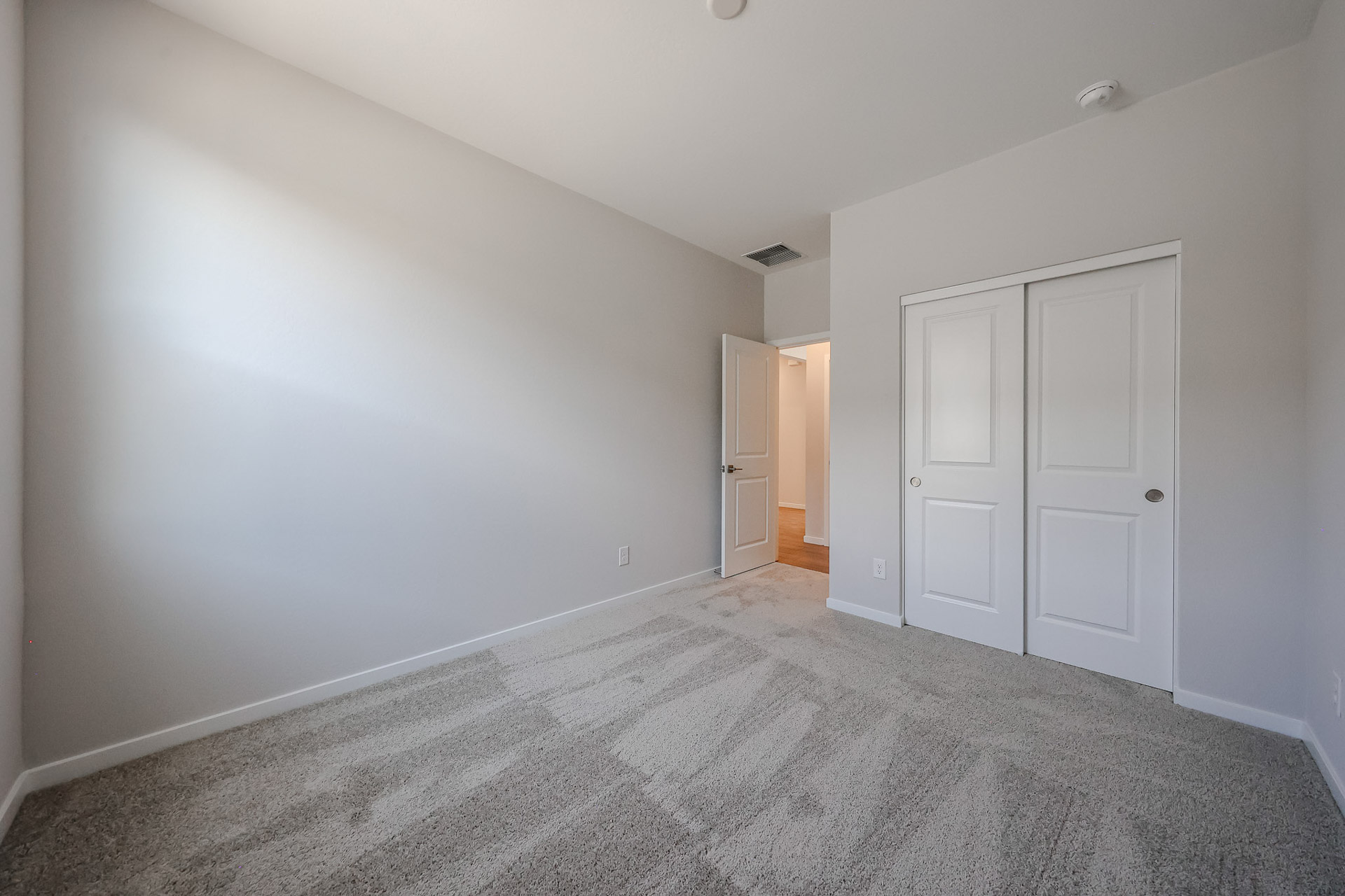 A hallway with white doors.