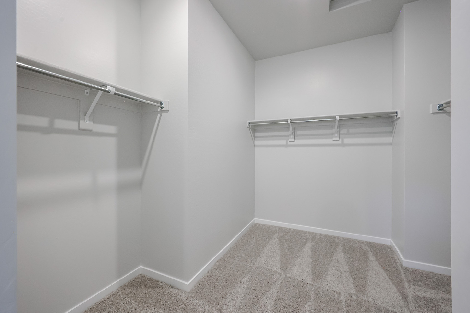 A white room with a metal railing.