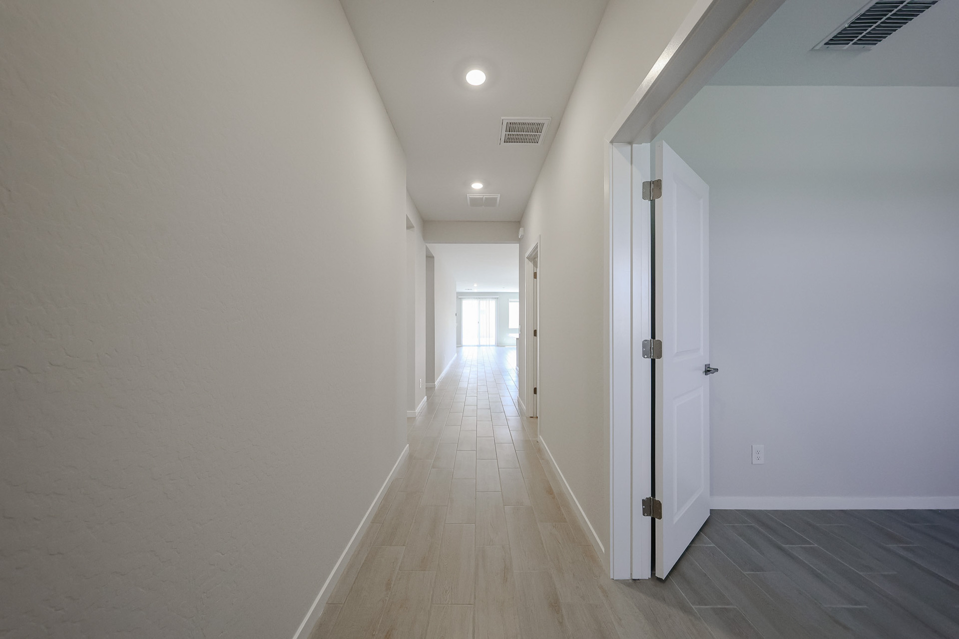 A hallway with white doors.