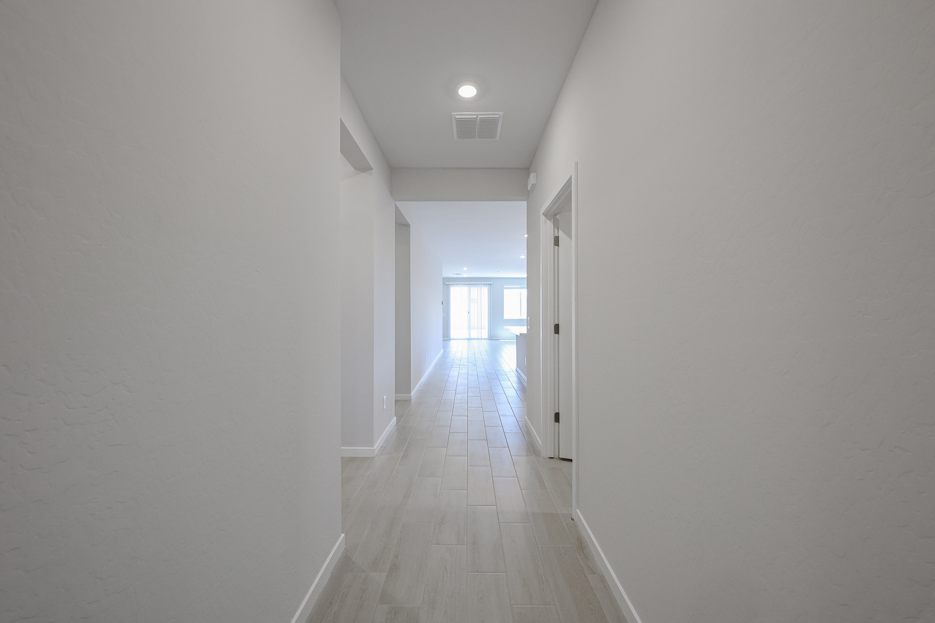 A long hallway with white walls.
