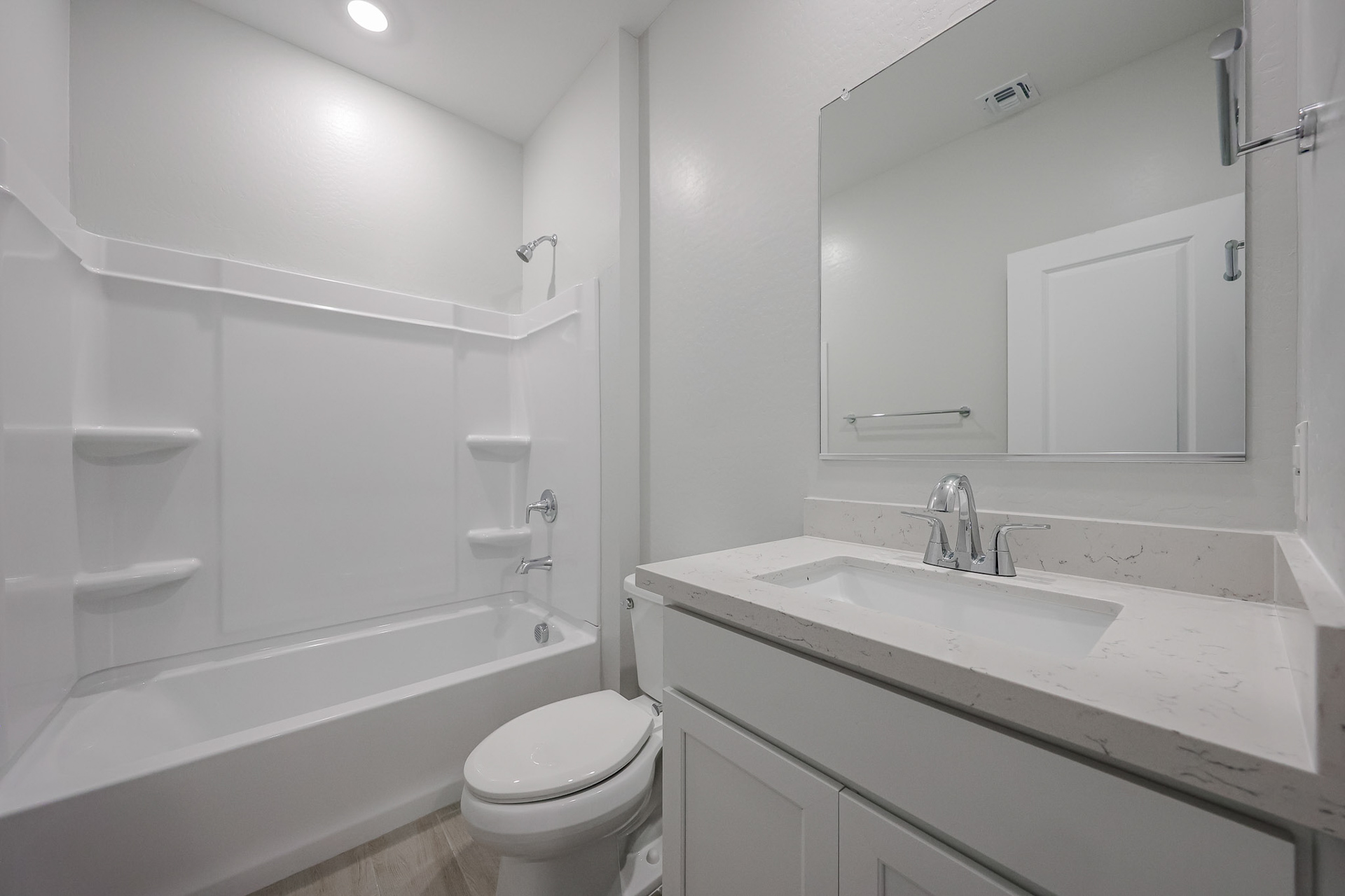 A bathroom with a tub sink and toilet.