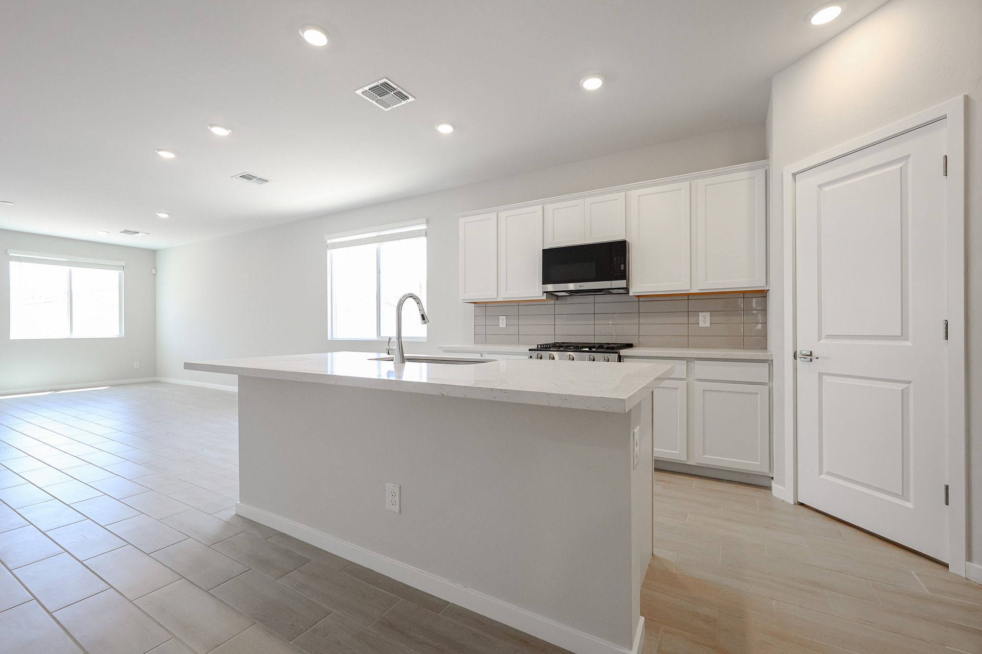 A kitchen with white cabinets.