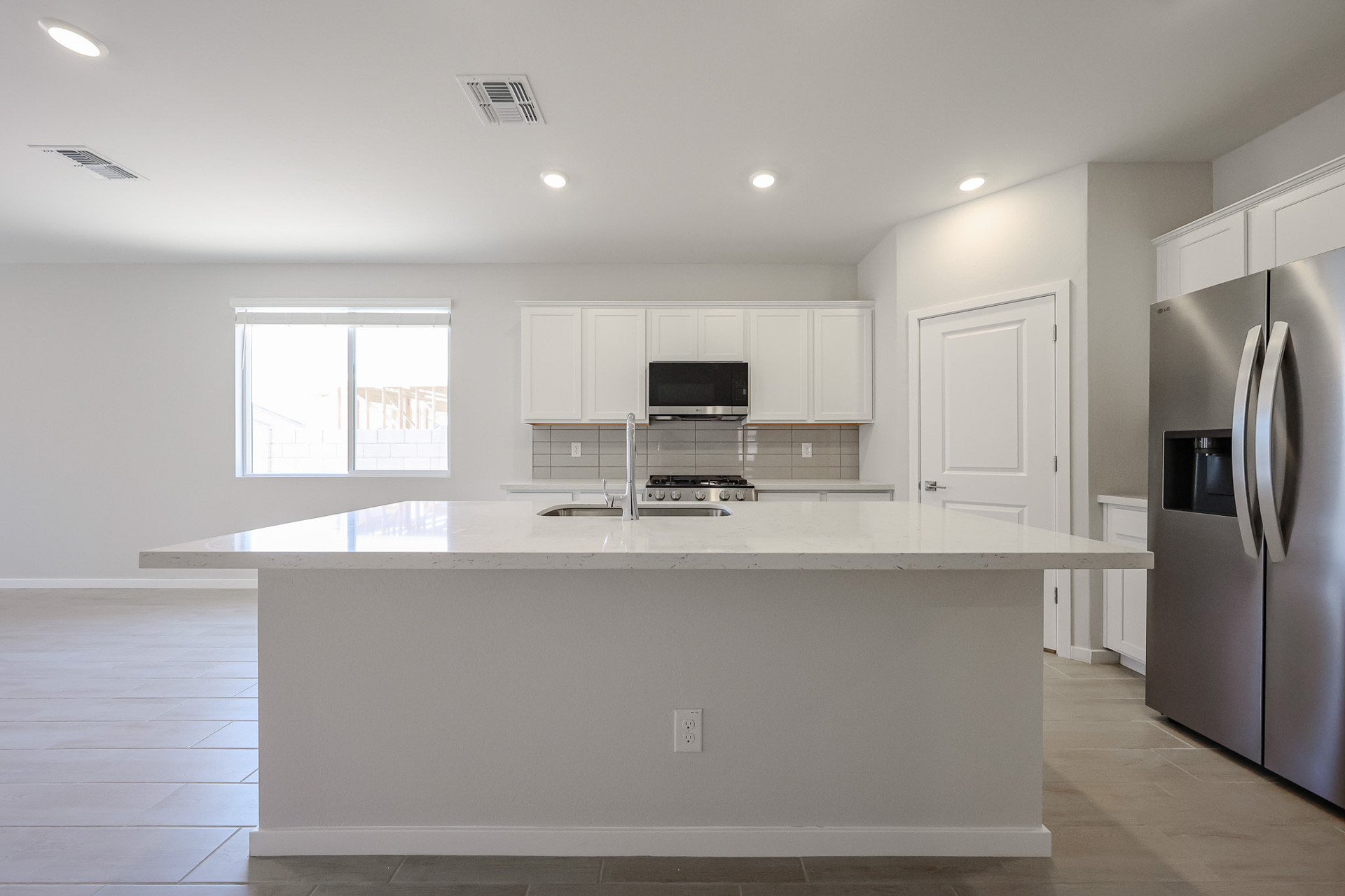 A kitchen with white cabinets.