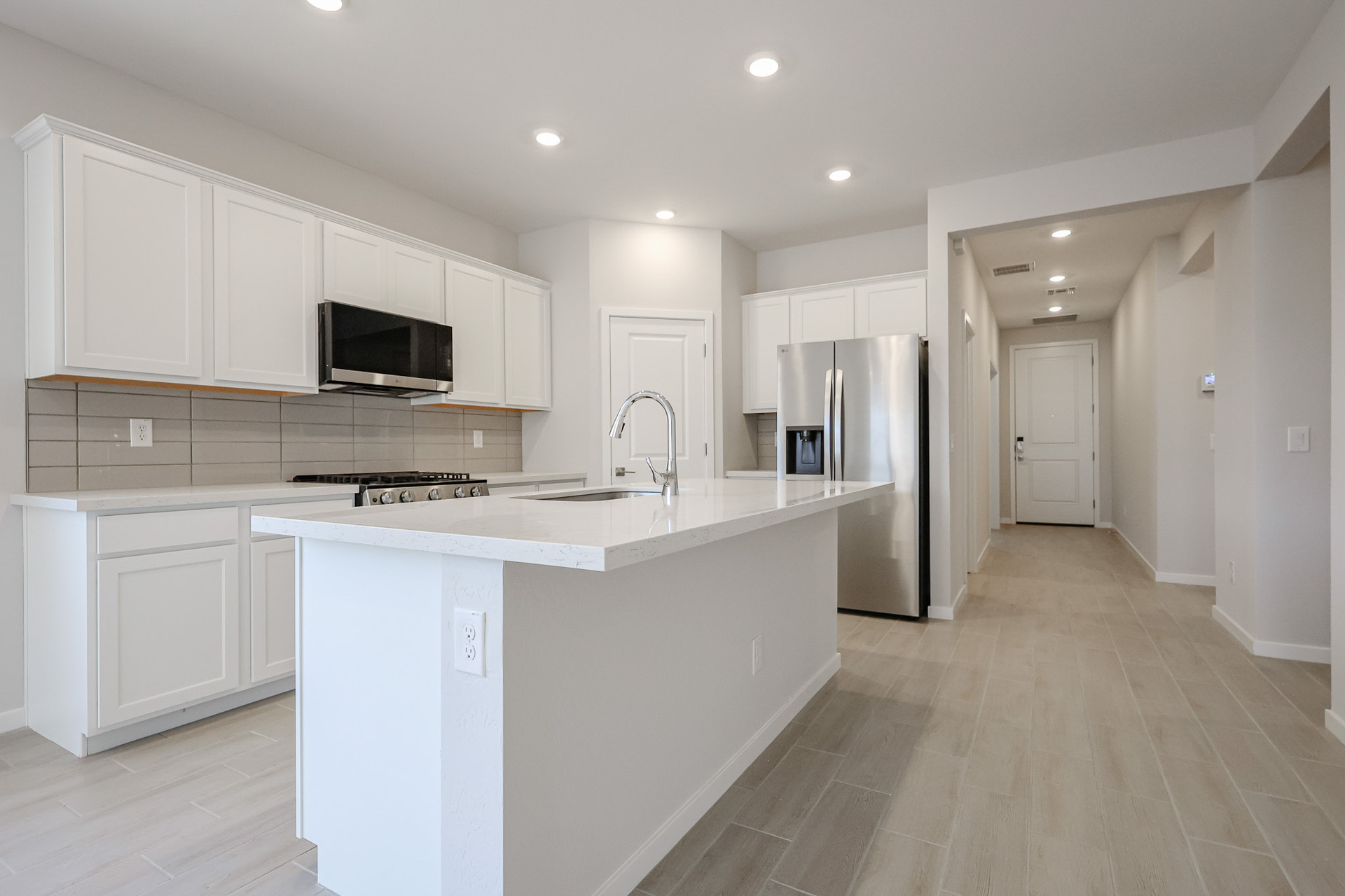 A kitchen with white cabinets.