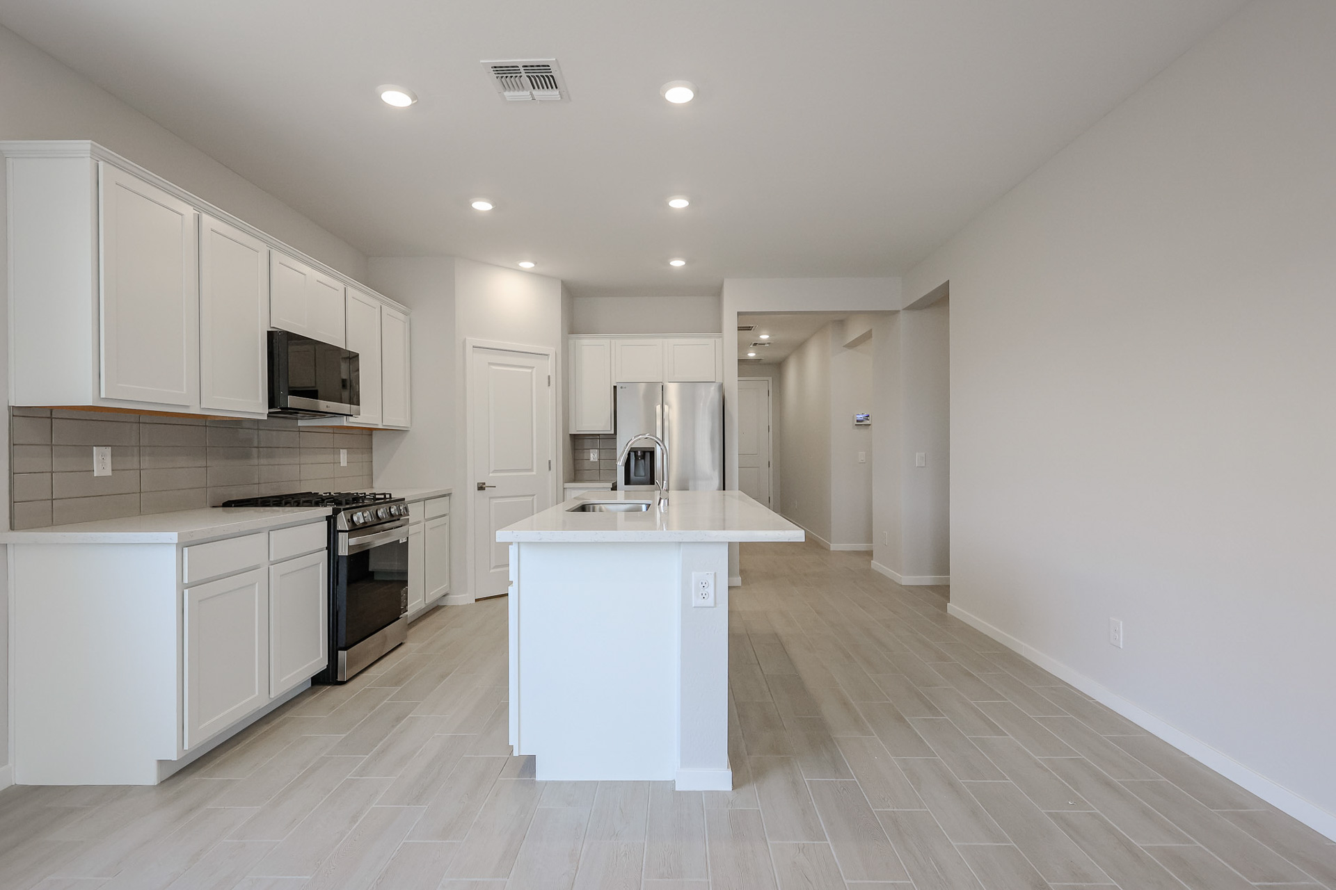 A kitchen with white cabinets.