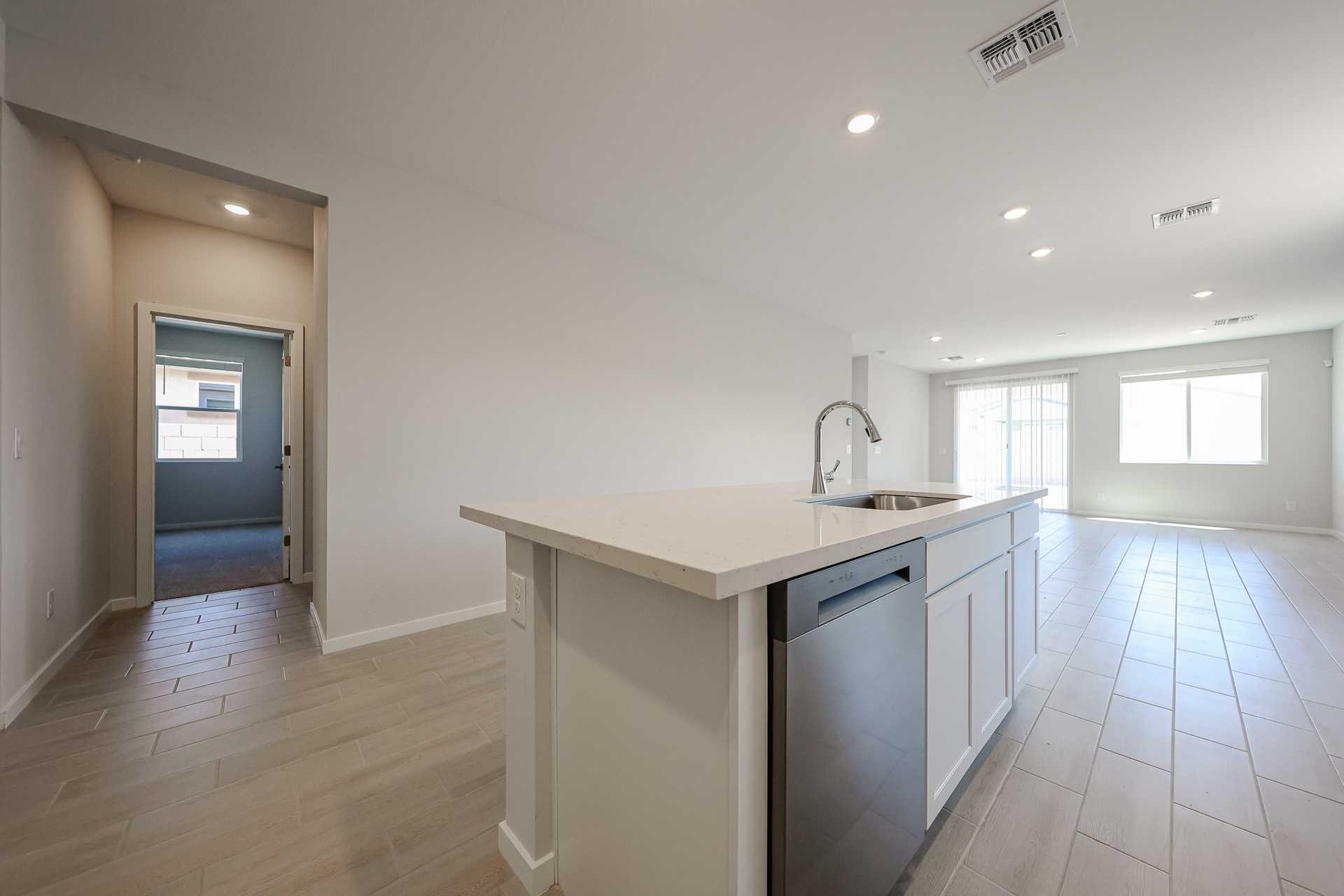 A kitchen with white cabinets.