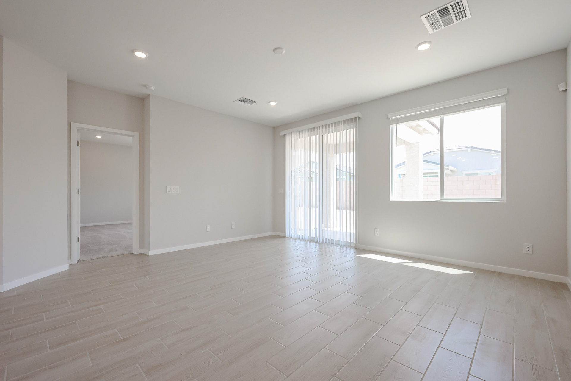 A room with a tile floor and windows.