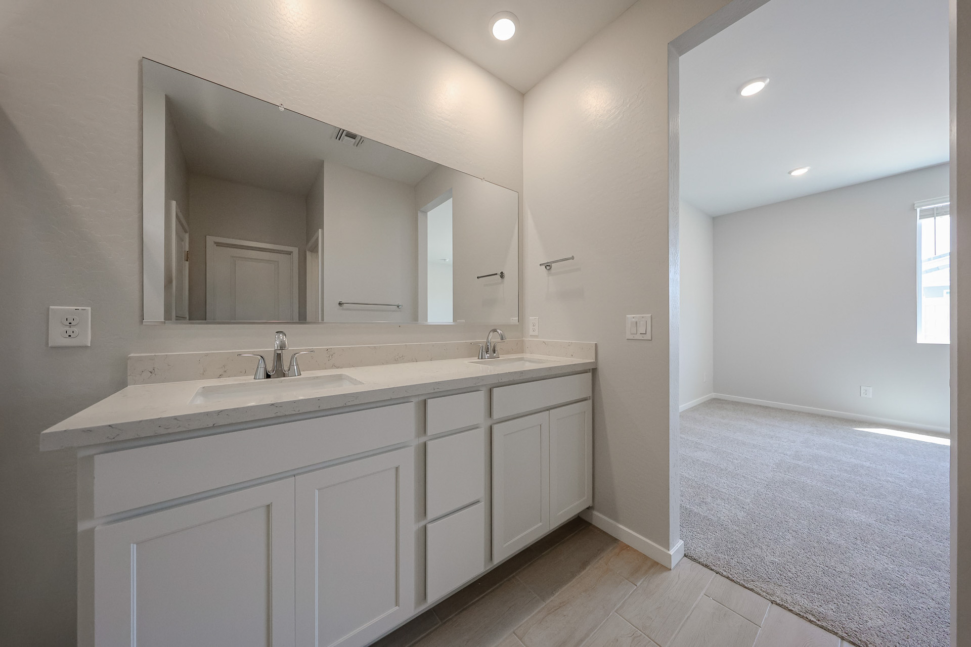 A bathroom with a large mirror.
