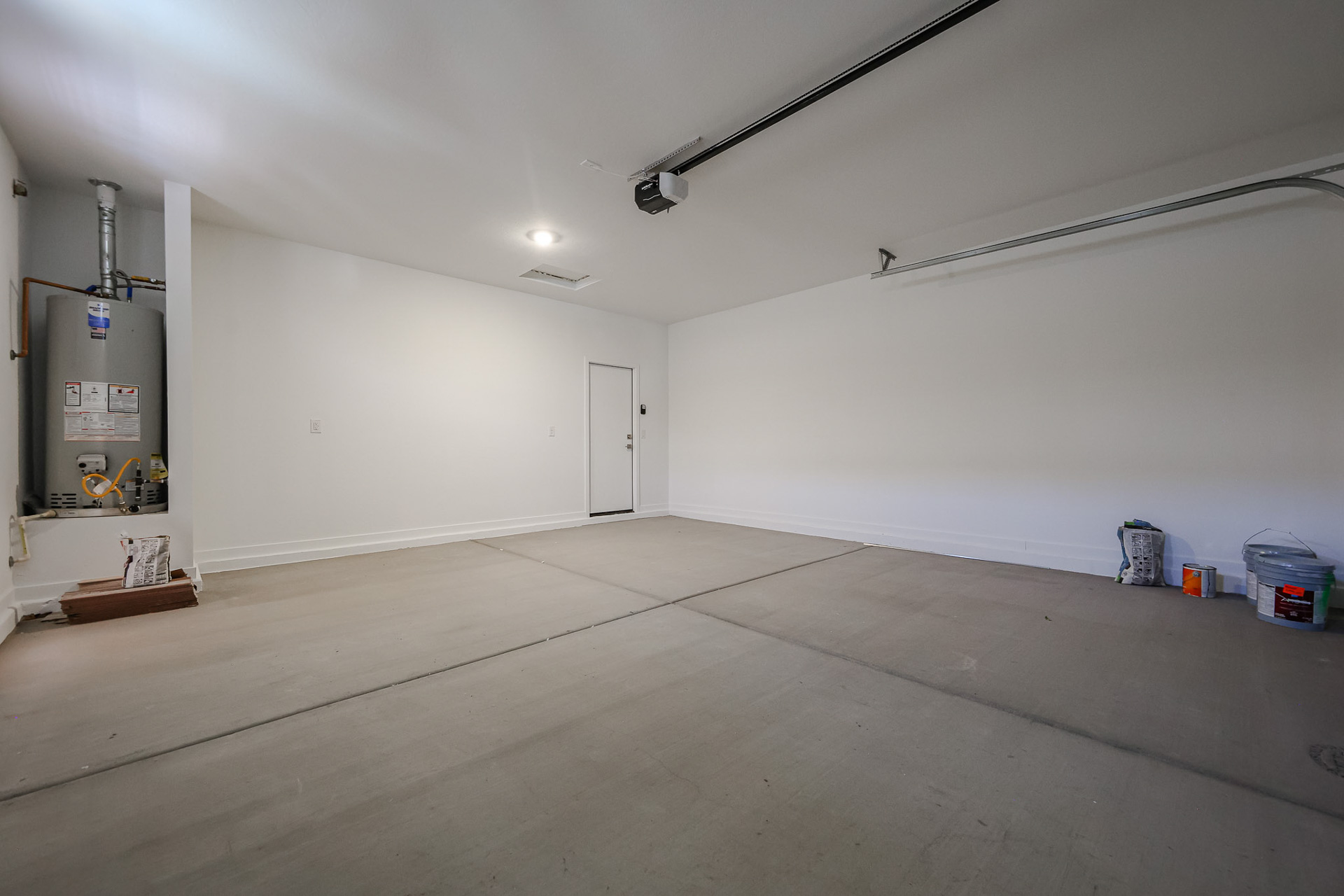 A room with a concrete floor and a white wall.