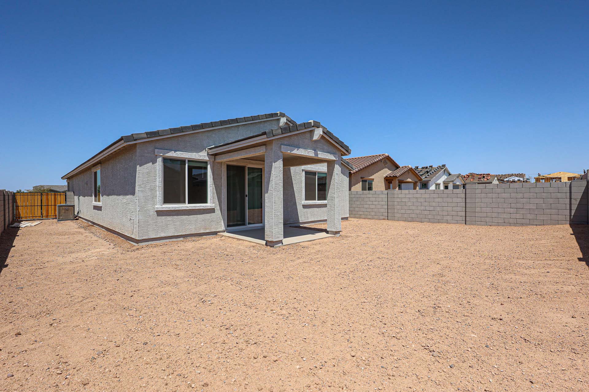 A house in a dirt field.