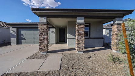 A house with a stone patio.