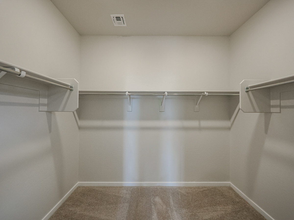 A white room with a metal bar.