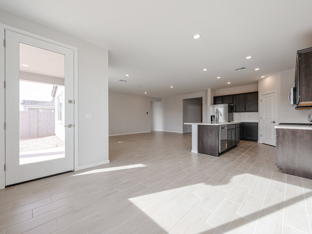 A large kitchen with a glass door.