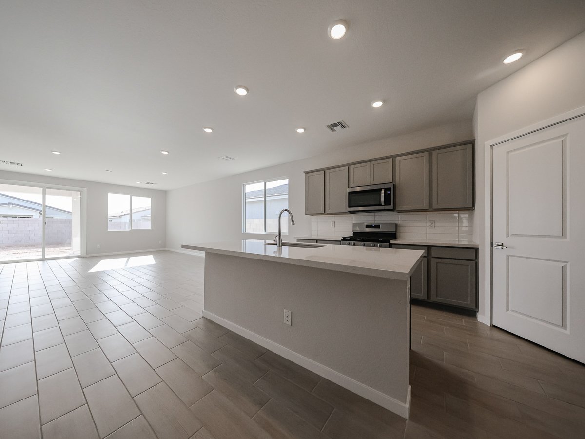 A kitchen with white cabinets.