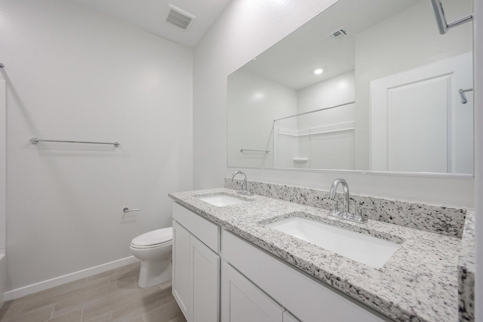 A bathroom with a marble countertop.