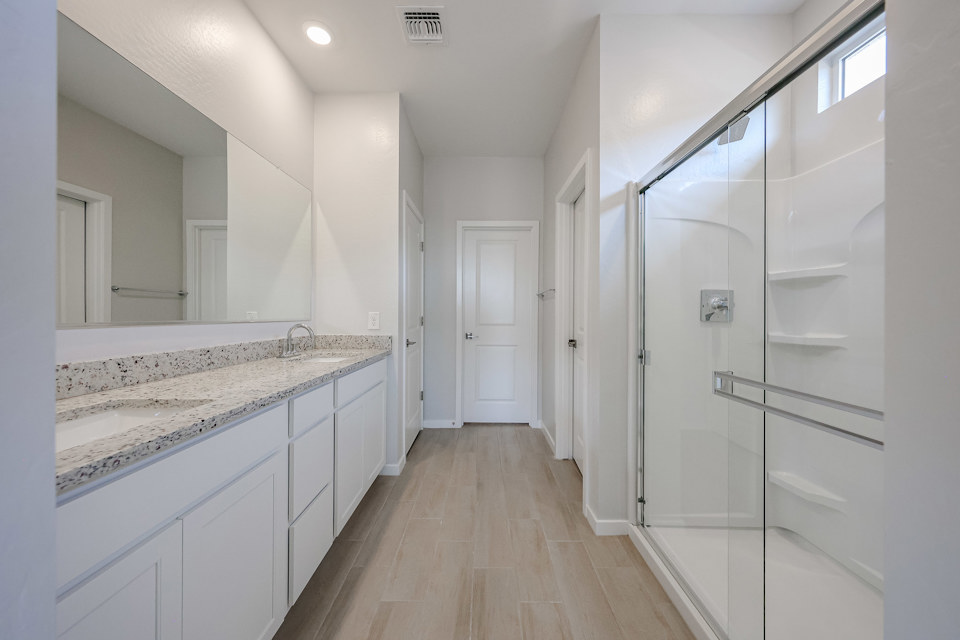 A bathroom with white cabinets.