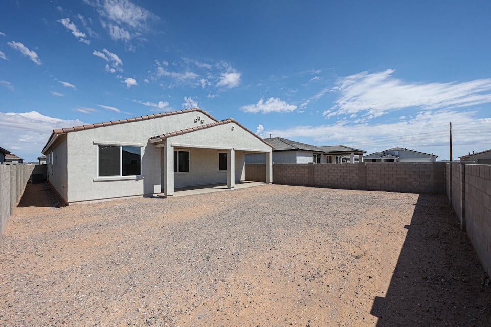 A house with a dirt yard.