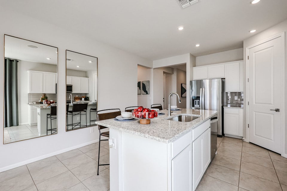 A kitchen with white cabinets.