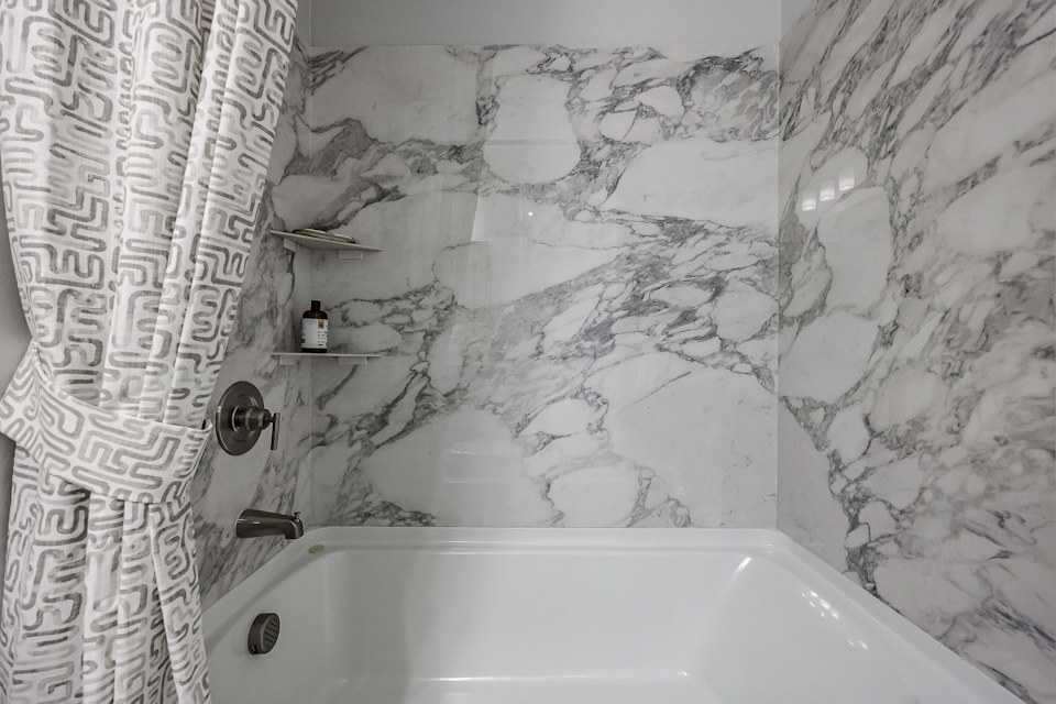 A bathroom with a tub and sink.