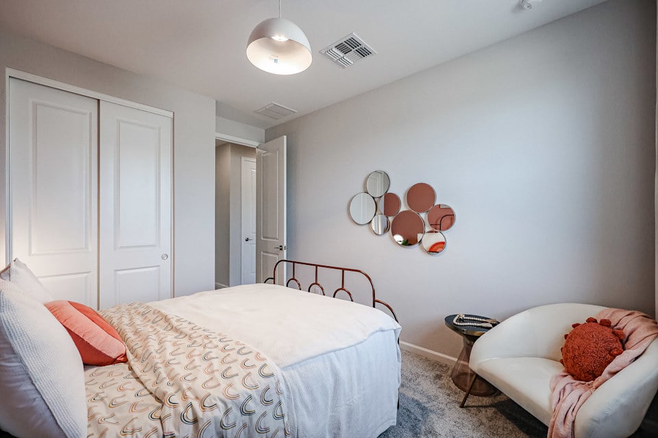 A bedroom with a bed and a couch.