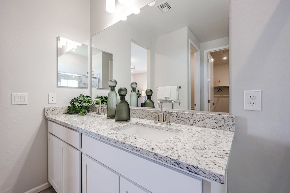 A bathroom with a large mirror.