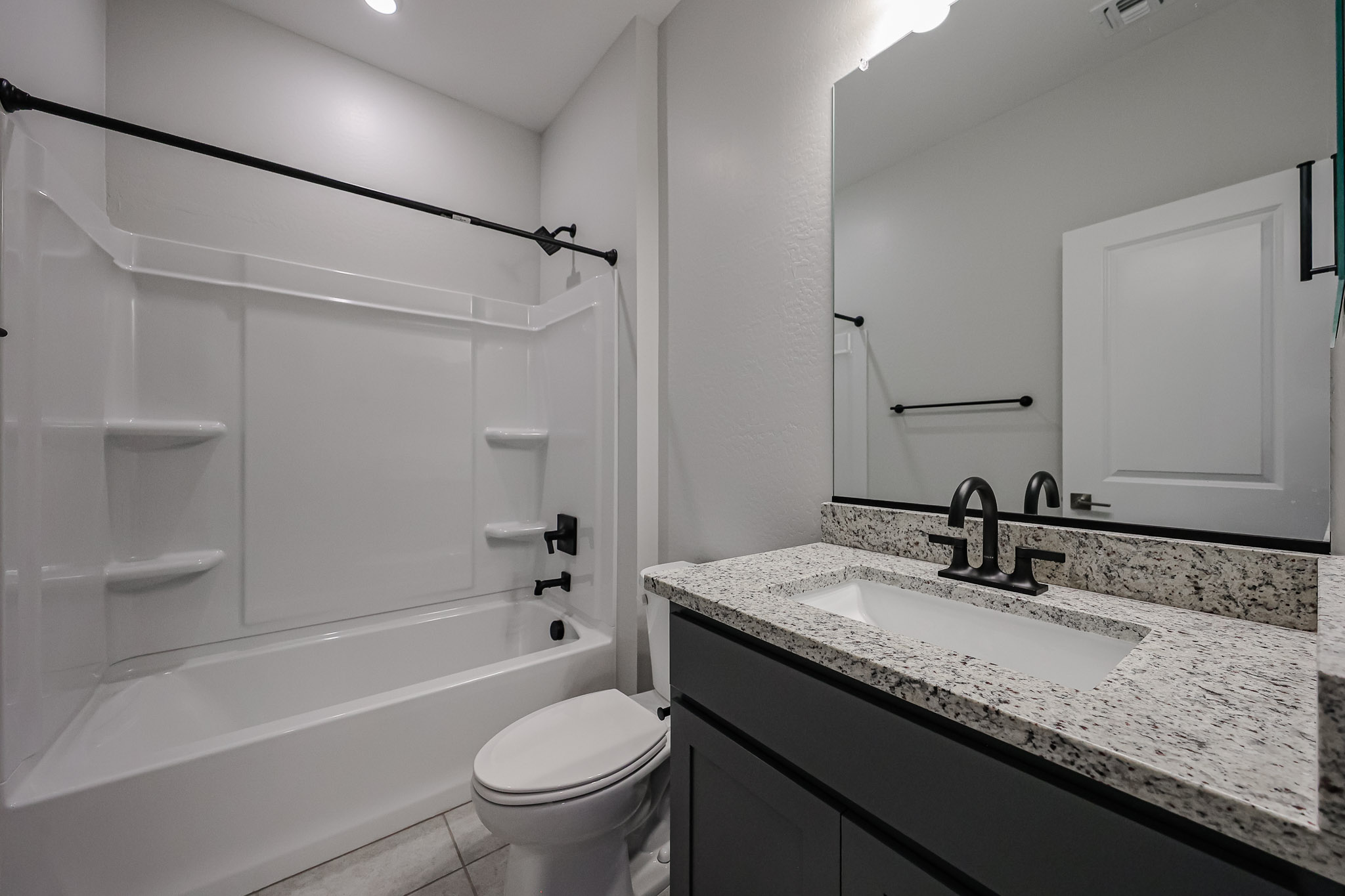 A bathroom with a tub sink and toilet.