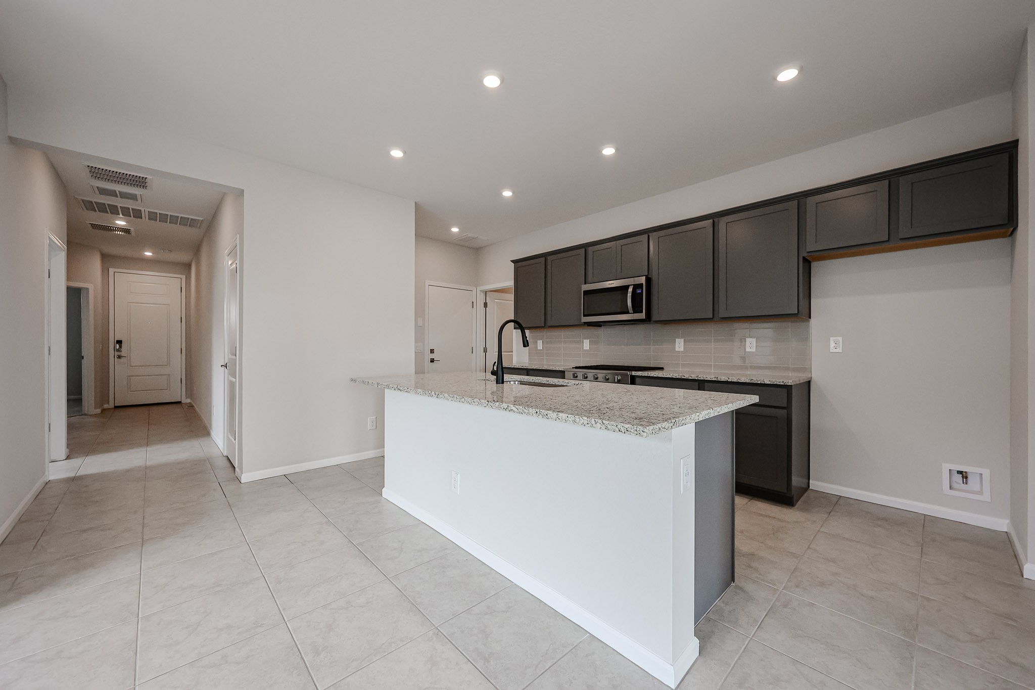 A kitchen with black cabinets.