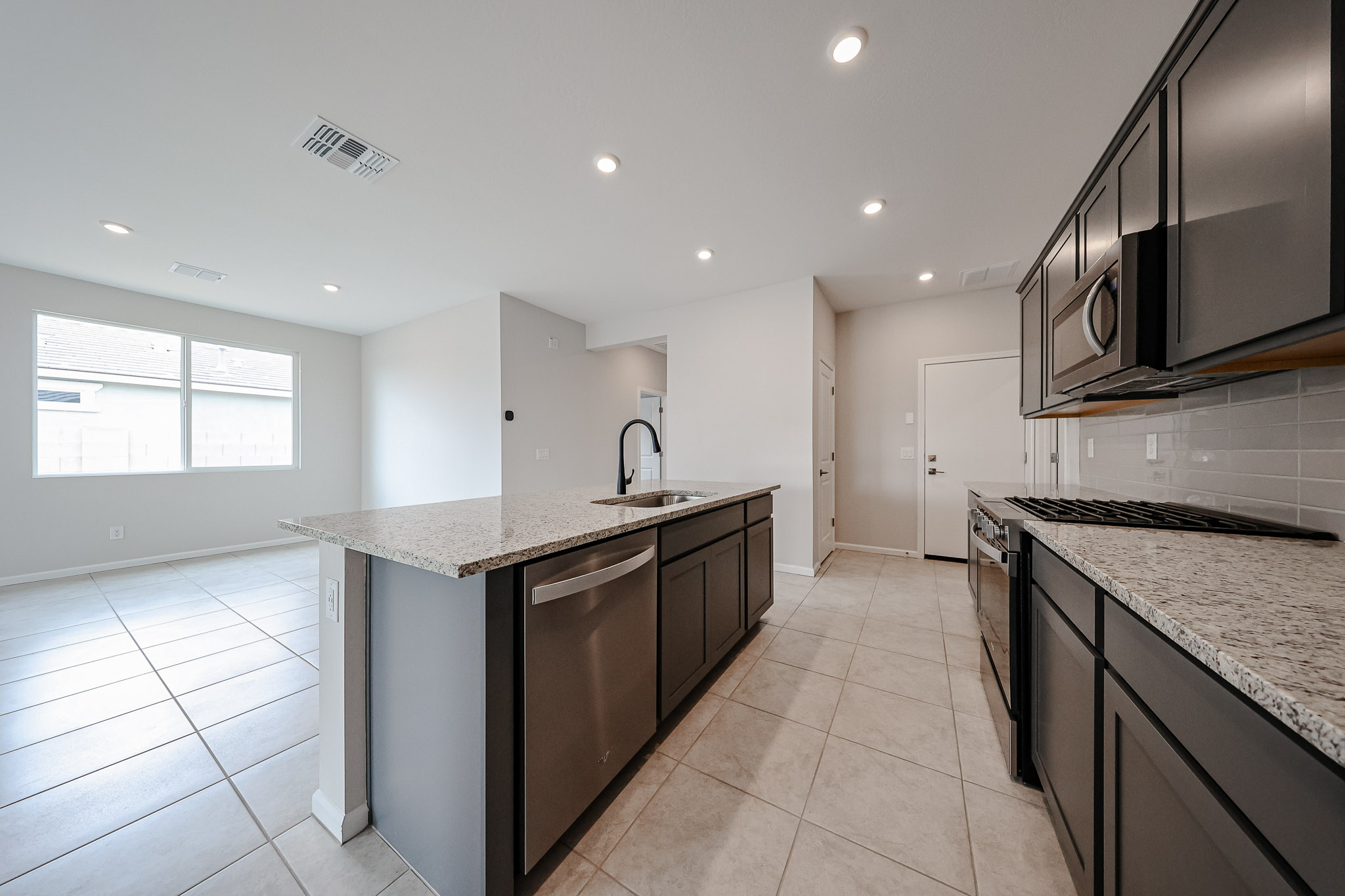 A kitchen with marble counters.