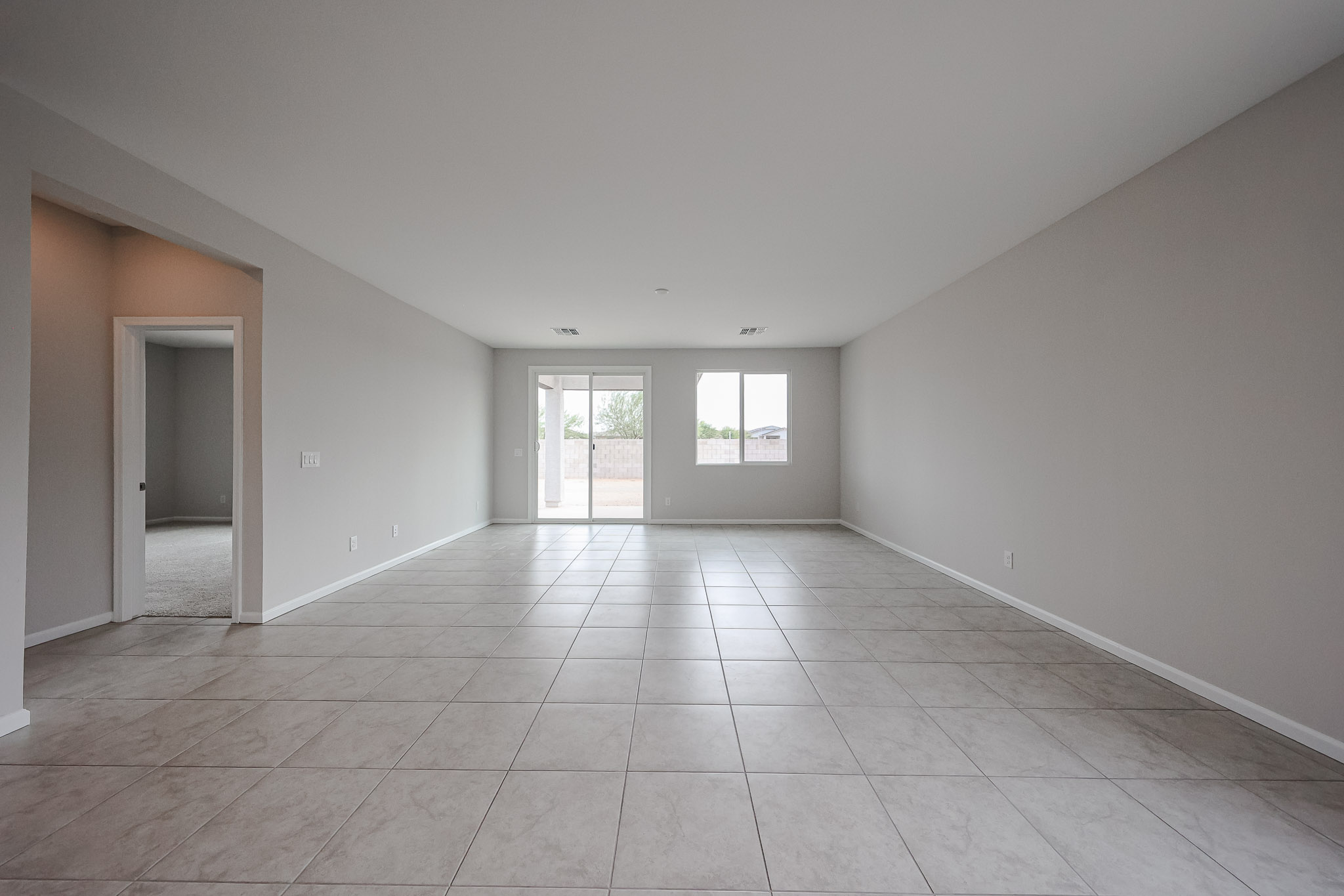 A room with a tile floor and a door.