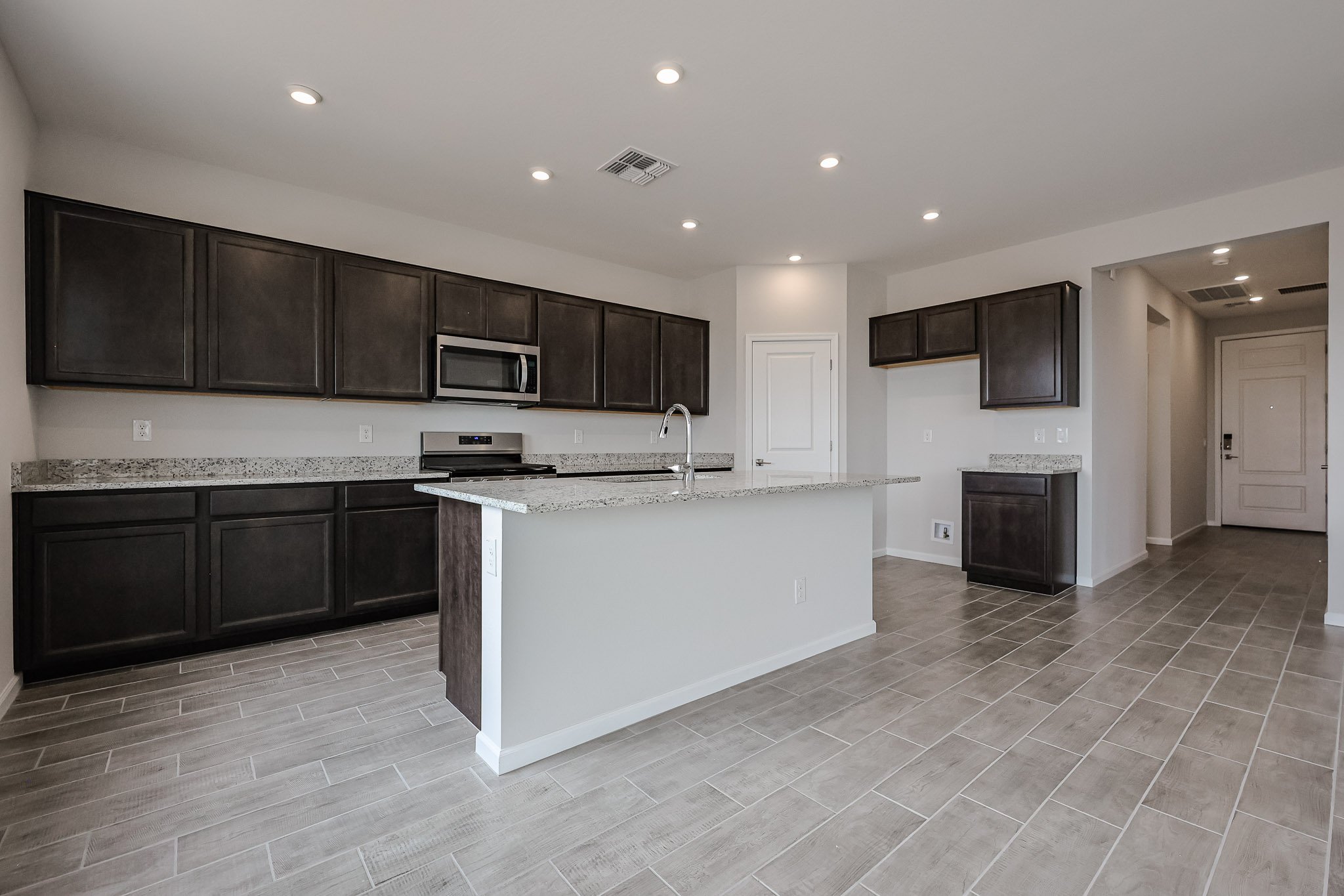 A kitchen with black cabinets.