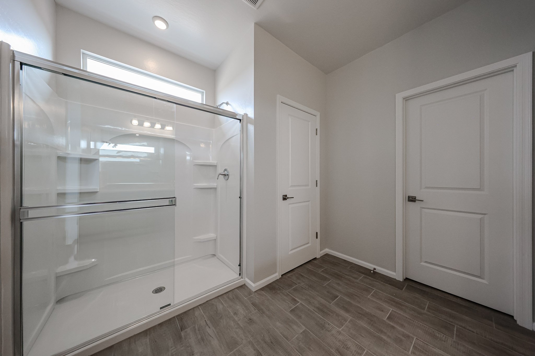 A bathroom with white cabinets.
