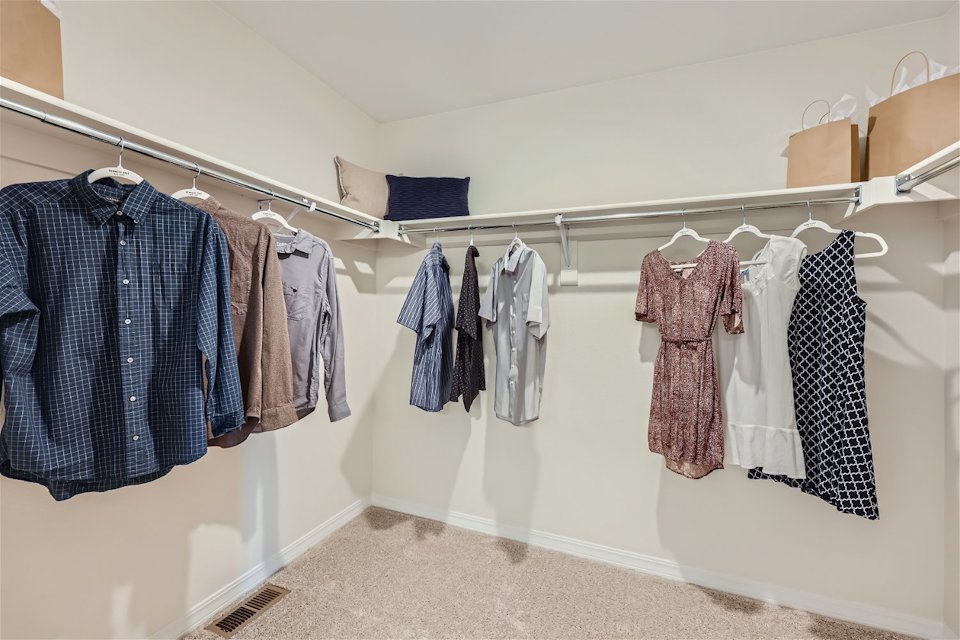A group of clothes on a rack.