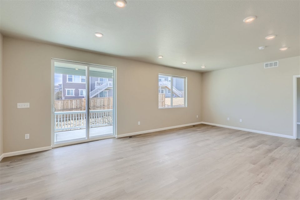 A room with a wood floor and a glass door.