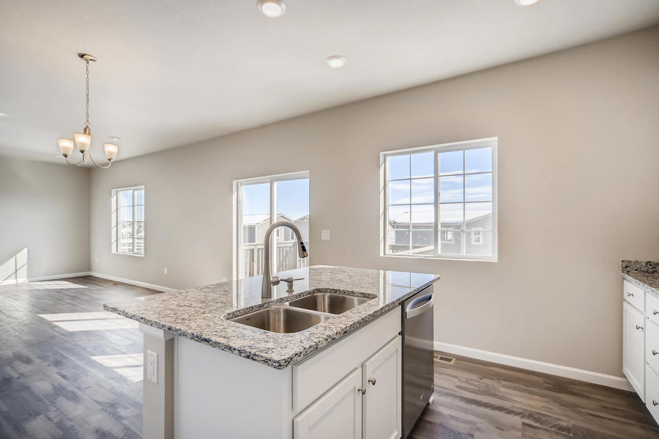 A kitchen with marble counters.