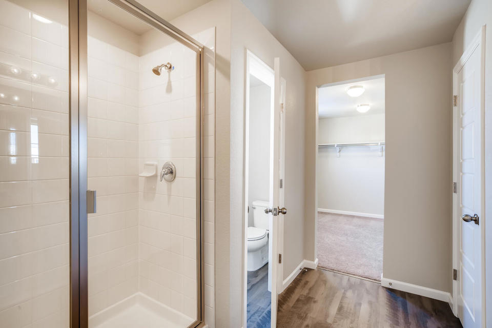 A bathroom with a shower unit.