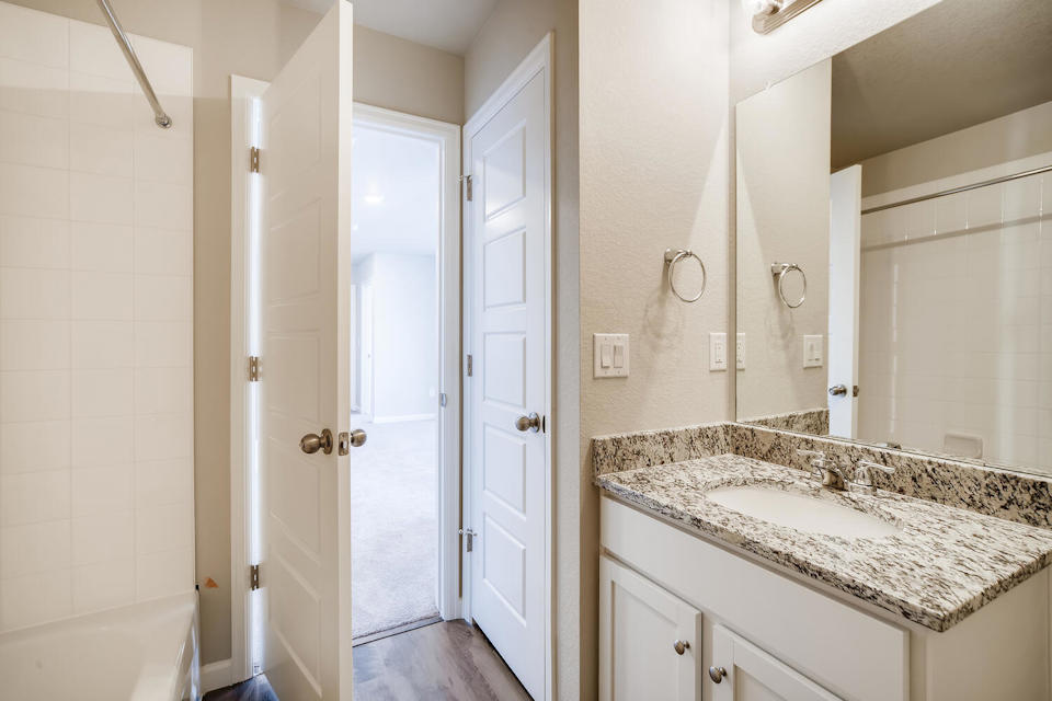 A bathroom with a marble countertop.
