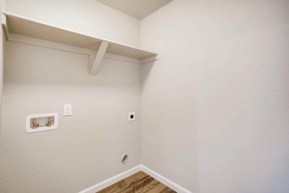 A white wall with a light fixture.