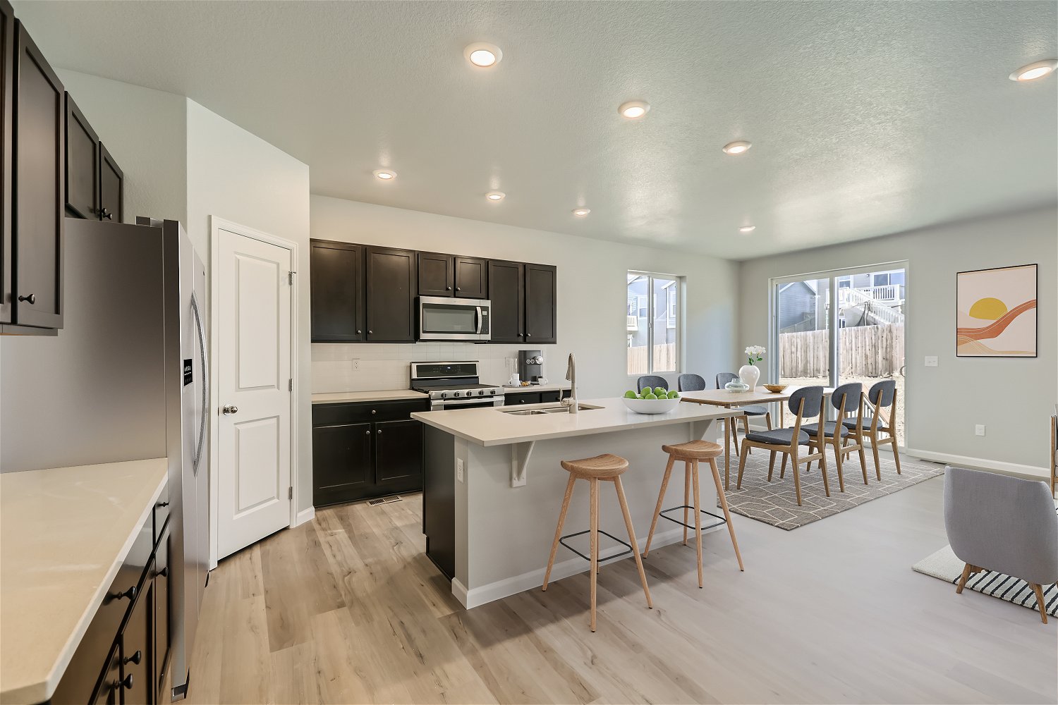 A kitchen with a bar stool and a table.