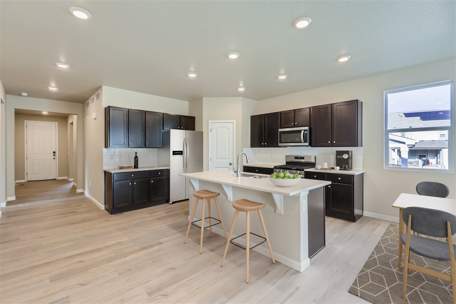 A kitchen with black cabinets.