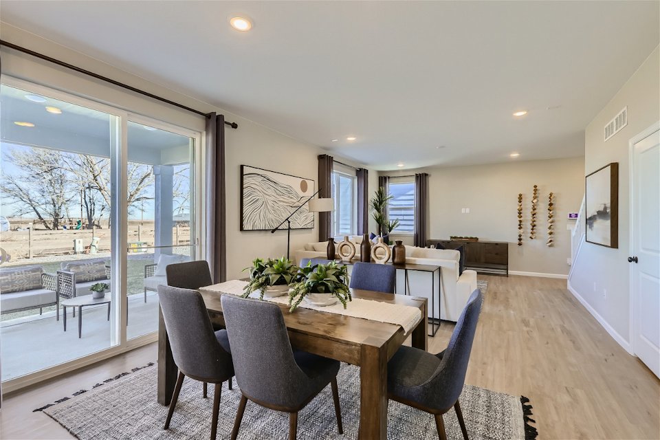 A dining room with a large glass door.