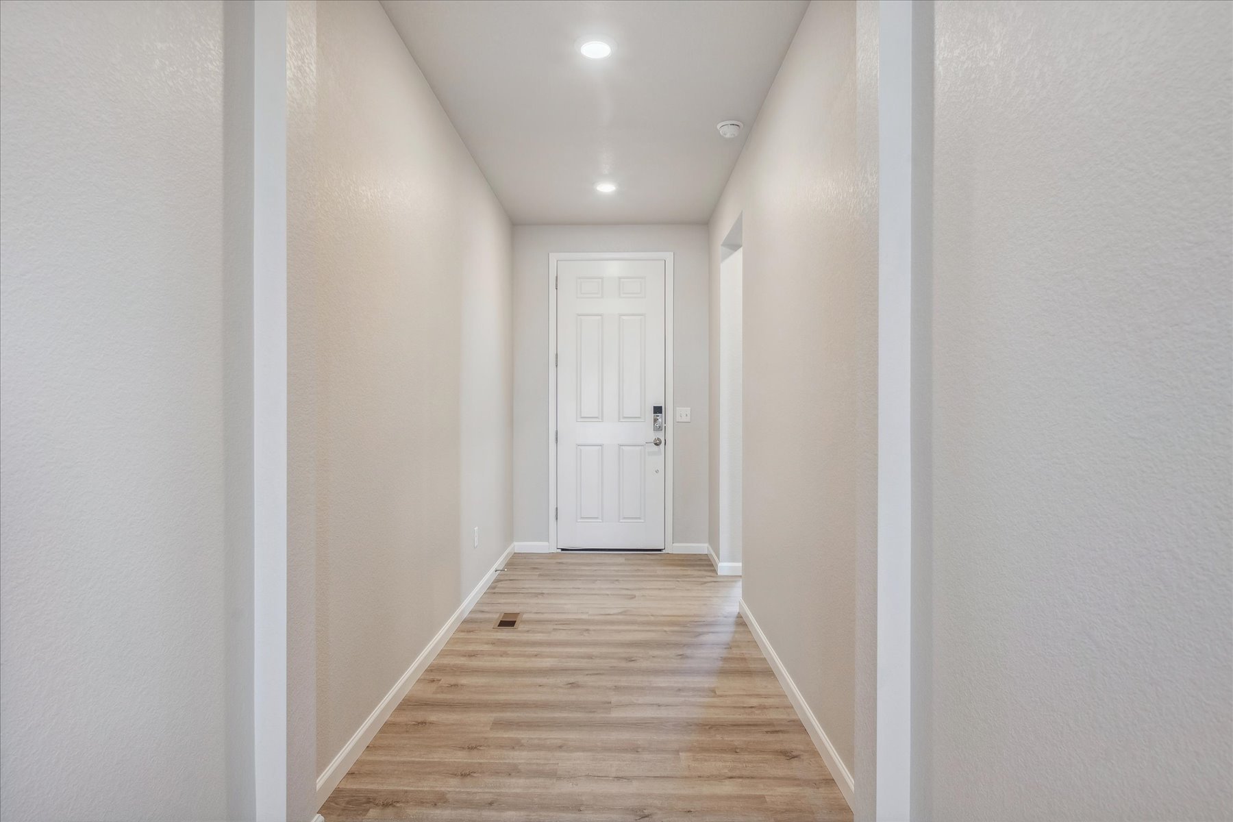 A hallway with white walls.