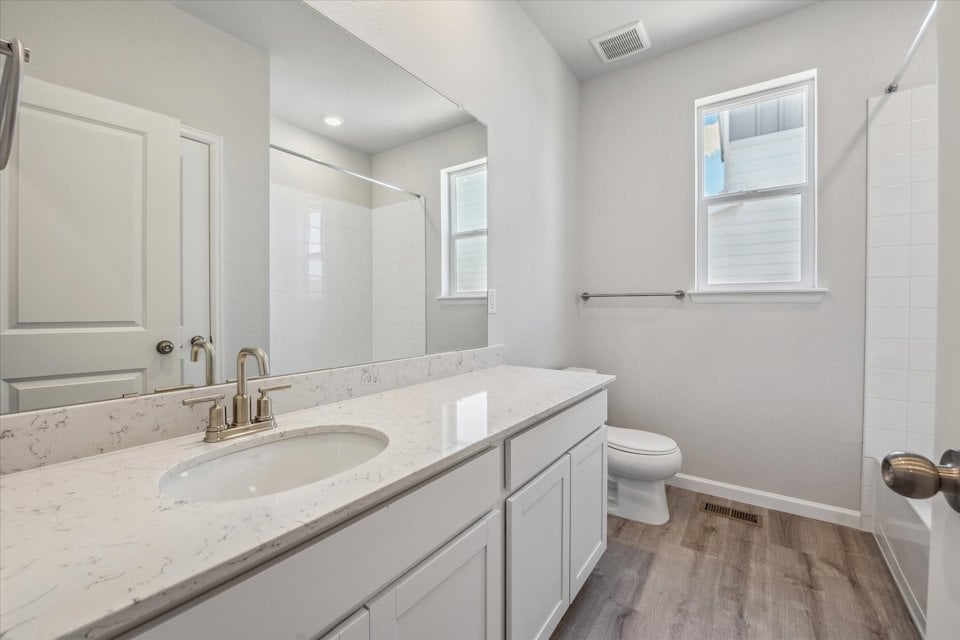 A bathroom with a sink and a toilet.