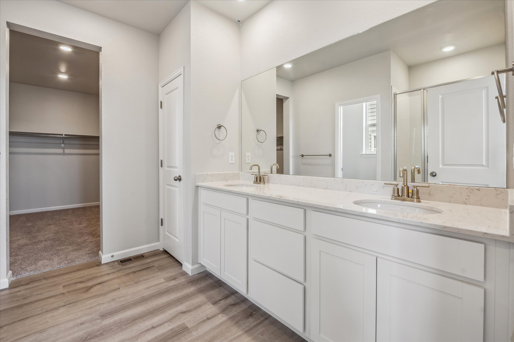 A bathroom with white cabinets.