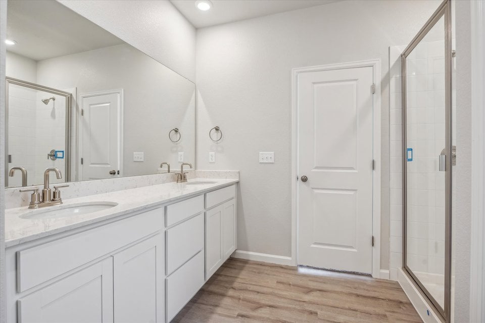 A bathroom with white cabinets.